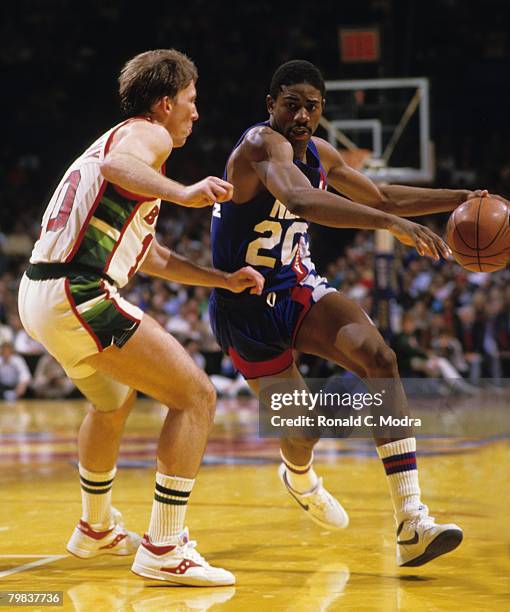 Michael Ray Richardson of the New Jersey Nets dribbling the ball as Mike Dunleavy of the Milwaukee Bucks defends during the 1984 NBA Playoffs in May...