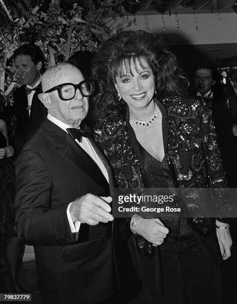 Author Jackie Collins is greeted by Irving "Swifty" Lazar at his 1989 West Hollywood, California, Oscar Party held at Spago.