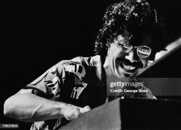 Jazz pianist Chick Corea plays an electronic keyboard that is reflected in his glasses in this 1980 Los Angeles, California, concert photo.