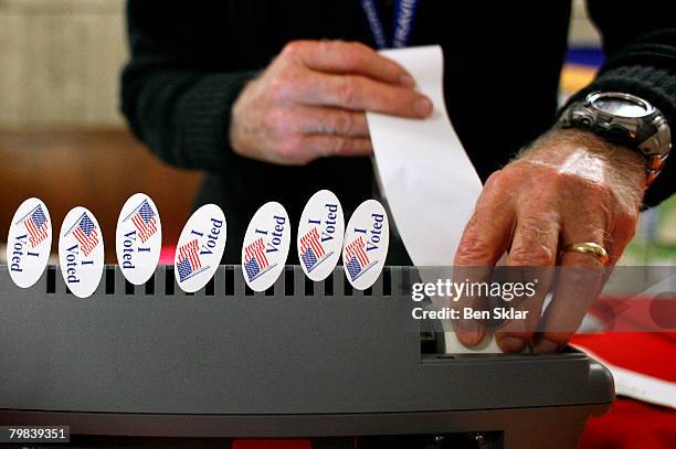 Pollster loads paper in a primary registration machine at the Travis County Courthouse February 19, 2008 in Austin, Texas. Early voting begins today...