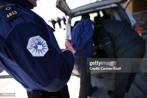 Officers of the Kosovo border police check cars at a checkpoint to Serbia on February 19, 2008 in Merdar, Kosovo. U.N. Police pulled out on Tuesday...