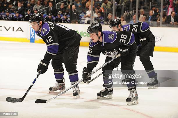 Patrick O'Sullivan, Kevin Dallman, and Alexander Frolov of the Los Angeles Kings await a faceoff during their game against the Phoenix Coyotes at...