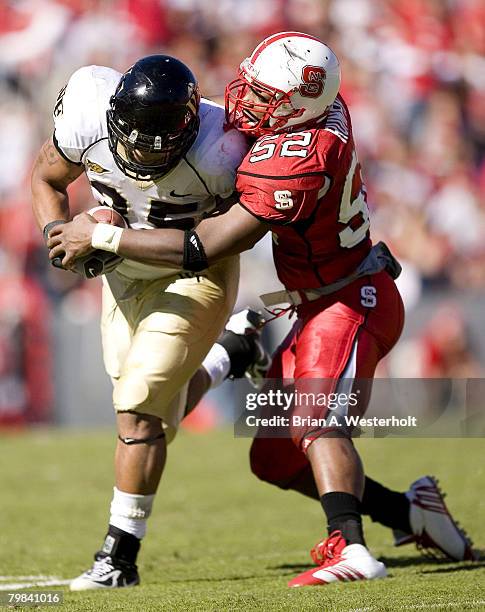 North Carolina State linebacker Lerue Rumph tries to bring down Wake Forest fullback Richard Belton during second half action at Carter Finley...