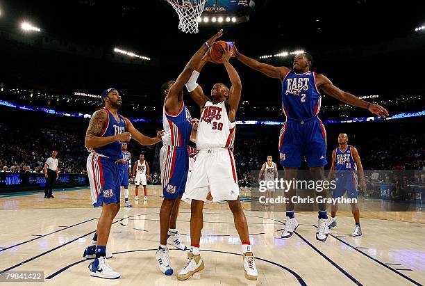 David West of the Western Conference goes up against Rasheed Wallace, Antawn Jamison and Joe Johnson of the Eastern Conference during the 57th NBA...