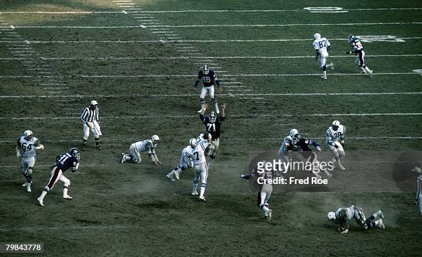 Baltimore Colts quarterback Bert Jones threads his pass past New York Giants defensive end Dave Gallagher during a 21-0 Colts victory on December 7...