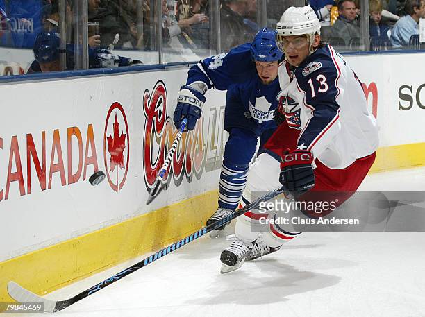 Nikolai Zherdev of the Columbus Blue Jackets chases after the puck with Brian McCabe of the Toronto Maple Leafs on his tail in a game on February 19,...