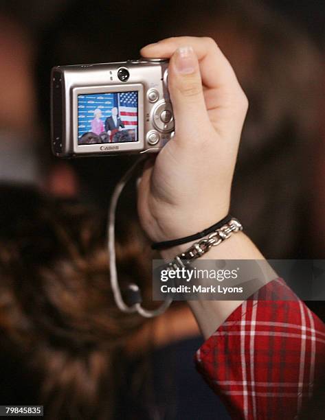 Supporter takes a picture as Republican presidential hopeful Sen. John McCain speaks while wife Cindy looks on during a campaign rally at the Hayes...