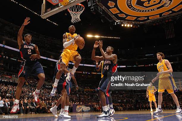 Kobe Bryant of the Los Angeles Lakers goes up for a reverse layup between Joe Johnson and Solomon Jones of the Atlanta Hawks at the Staples Center...