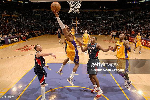 Kobe Bryant of the Los Angeles Lakers puts up a shot between Mike Bibby and Joe Johnson of the Atlanta Hawks during their game at the Staples Center...