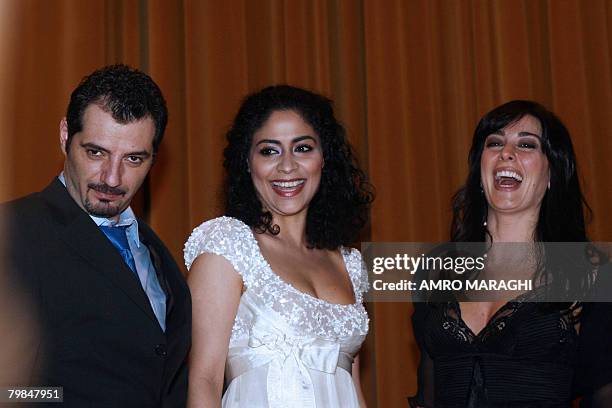 Lebanese film director and actress Nadine Labaki poses for a picture with actors from her film 'Caramel', Adel Karam and Yasmine al-Masri, during a...