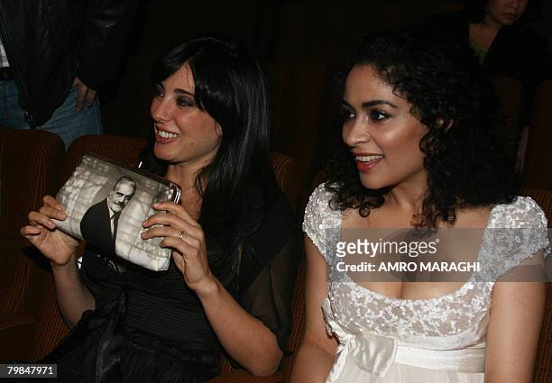Lebanese actress Yasmine al-Masri sits next to film director and actress Nadine Labaki -- holding a purse with a picture of Egyptian film star Omar...