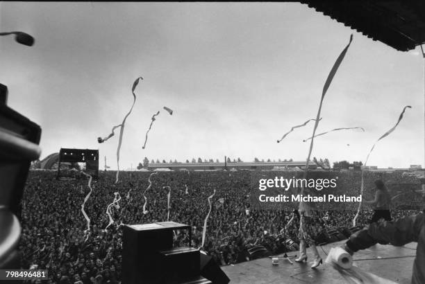 Noddy Holder and Dave Hill of British rock group Slade perform live on stage as toilet rolls are thrown in to the crowd at the Monsters of Rock...