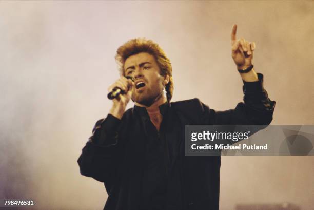 English singer, songwriter and musician, George Michael performs live on stage at an Aids awareness charity concert at Wembley Arena in London in...