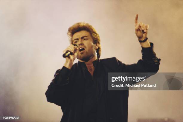 English singer, songwriter and musician, George Michael performs live on stage at an Aids awareness charity concert at Wembley Arena in London in...