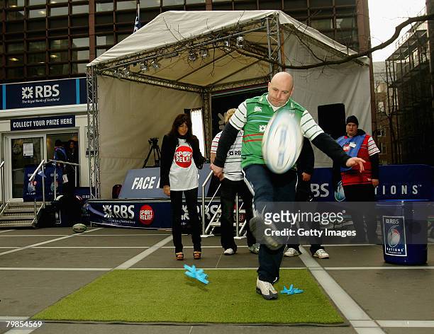 Former Irish rugby international, Keith Wood kicks a rugby ball, watched by TV presenter and Sports Relief Abassador Claudia Winkleman, during the...