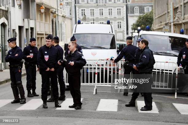 Police officers stand to secure the leaving of the Pau courthouse by two of the four alleged members of the Basque separatist group ETA arrested in...