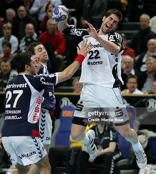 Nikola Karabatic of Kiel is attacked by Alexander Petersson and Blazenko Lackovic of Flensburg during the Bundesliga Handball match between THW Kiel...