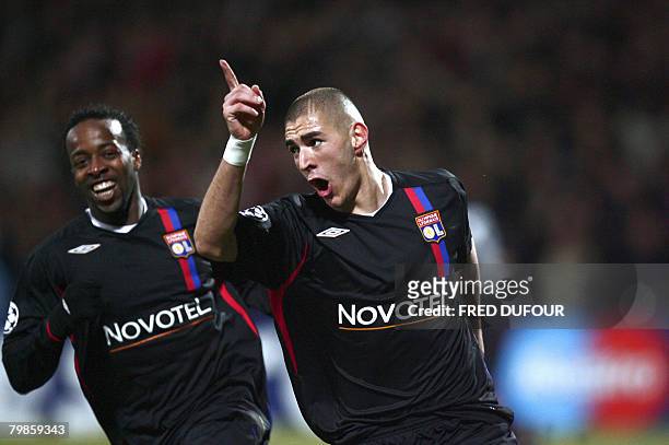Lyon French forward Karim Benzema celebrates with his teammate Sidney Govou after scoring a goal during the Champion's league football match Lyon vs...