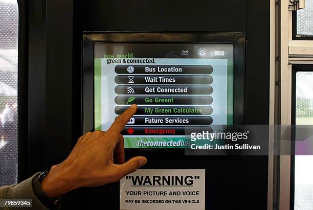 Reporter tests a touchscreen monitor on the Connected Bus, a new bus with high-tech features, February 20, 2008 in San Francisco, California. The...