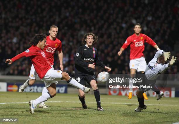 Carlos Tevez of Manchester United scores their first goal the UEFA Champions League first knockout round match between Olympique Lyonnais and...