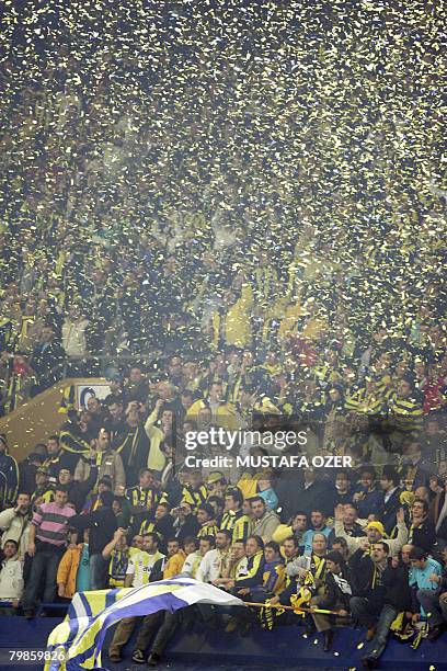 Fenerbahce Istanbul's fans celebrate after the Fenerbace and Sevilla eighth of finals Champions League football match at Sukru Saracoglu Stadium in...