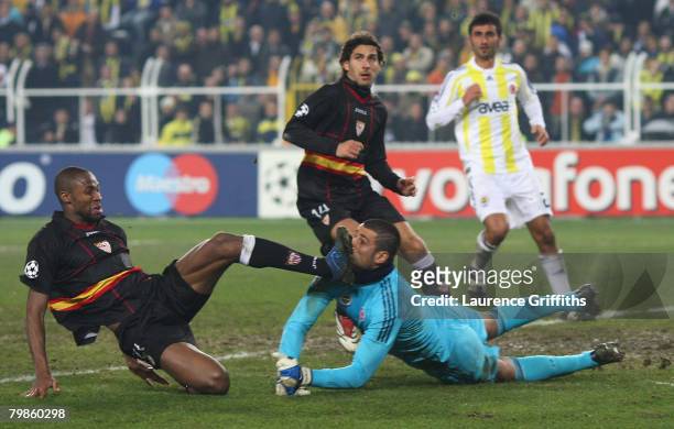 Volkan Demirel of Fenerbahce battles with Seydou Keita of Sevilla during the UEFA Champions League First Knock Out Round First Leg match between...