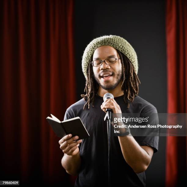 african man reading into microphone - poet stock pictures, royalty-free photos & images
