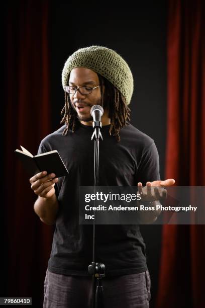 african man reading into microphone - poet stock pictures, royalty-free photos & images