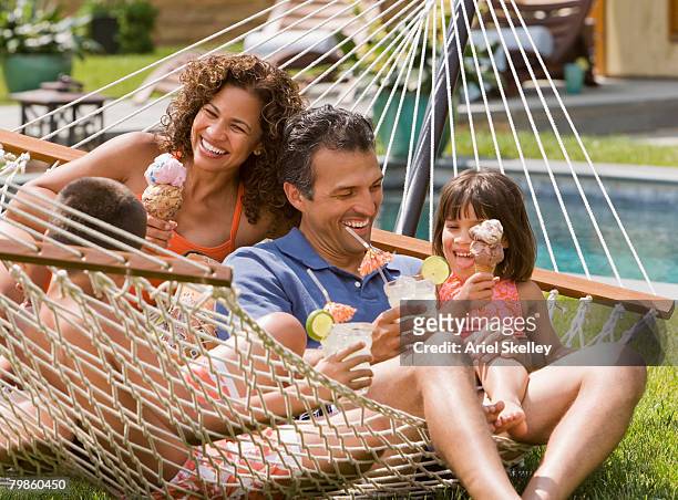 hispanic family eating ice cream in hammock - ice cream family stock pictures, royalty-free photos & images