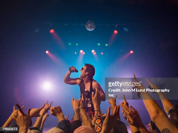 male rock star performing in front of audience - before they were famous stock pictures, royalty-free photos & images