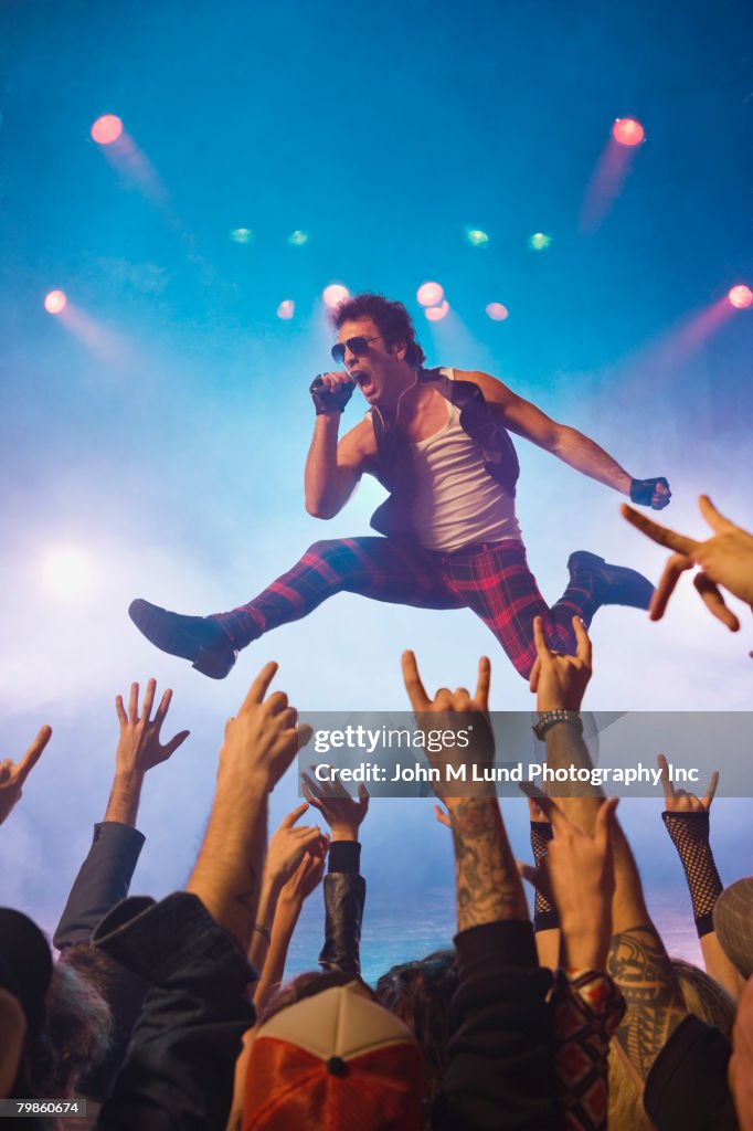 Male rock star performing in front of audience