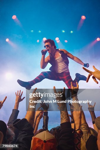 Male rock star performing in front of audience Male rock star performing in front of audience