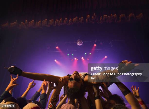 male rock star crowd surfing - musician male energy stock-fotos und bilder