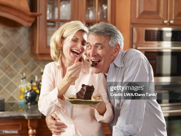 multi-ethnic couple eating cake - couple chocolate stock-fotos und bilder