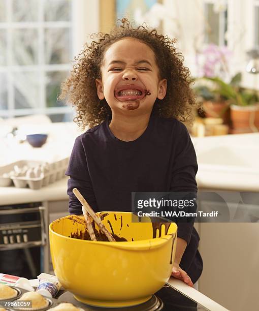 african girl with cupcake batter on face - girl baking stock pictures, royalty-free photos & images