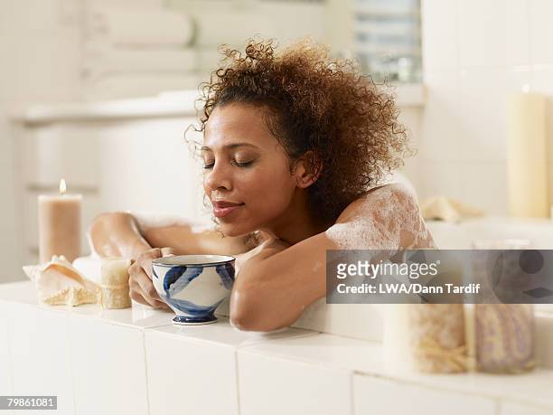 african woman in bubble bath - indulgence stockfoto's en -beelden