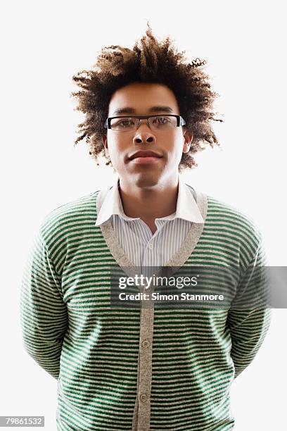 mixed race man wearing cardigan sweater - mixed race man standing studio stockfoto's en -beelden