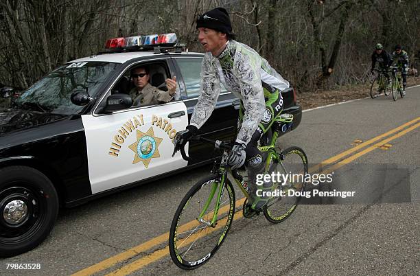 Tyler Hamilton of the USA and riding for Rock Racing is motioned off the course by California Highway Patrol as he and teammates Santiago Botero of...