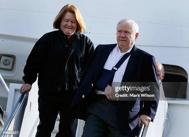 With his arm in a sling from slipping on the ice last week, U.S. Secretary of Defense Robert Gates and his wife Becky Gates arrive at Hickam AFB,...