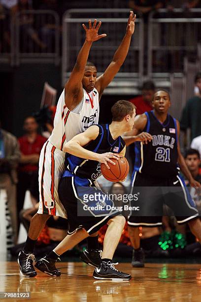 James Dews of the Miami Hurricanes plays defense against Jon Scheyer of the Duke Blue Devils at BankUnited Center on February 20, 2007 in Miami,...