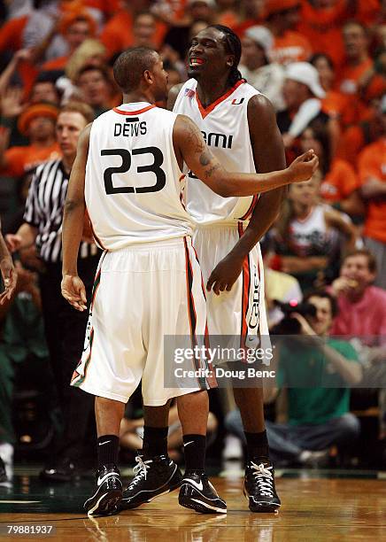 James Dews and Dwayne Collins of the Miami Hurricanes celebrate after Collins was fouled while scoring against the Duke Blue Devils at BankUnited...
