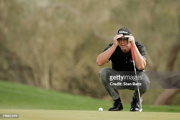 Steve Stricker studies his line at the first green during the first-round matches of the WGC-Accenture Match Play Championship at The Gallery at Dove...