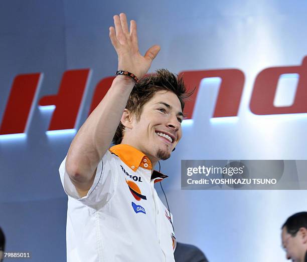 Honda's Moto GP rider Nicky Hayden waves as he attends a press meeting for Honda's motor sports at a Tokyo hotel on February 21, 2008. Formula one...