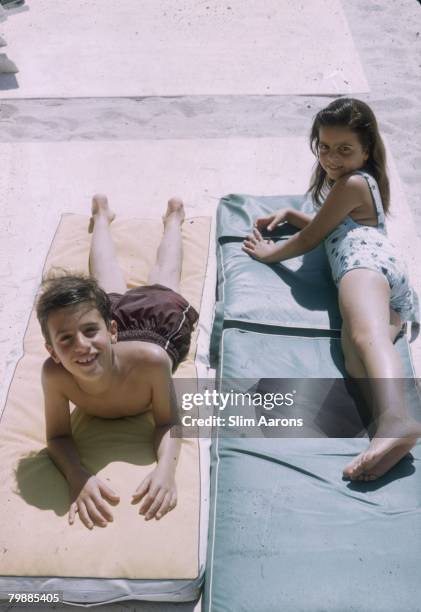 Alexander Onassis and his sister Christina and at the Monte Carlo Beach Club, 1958.