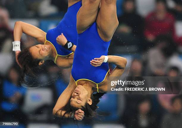 Cuban divers Yaima Mena and Annia Rivera compete in the Women's 10M Synchro PLatform on February 21, 2008 during a test event at the National...