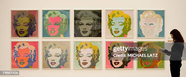 Woman stands beside the work "Marilyn Monroe" by US artist Andy Warhol presented at the Staatsgalerie museum in Stuttgart, southern Germany, on...