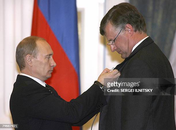 Russian President Vladimir Putin decorates Frederik Dag Arfst Paulsen , a Swedish member of the 2007 Arctic deep-water expedition and Russia's...