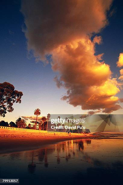 clouds over beach at sunset - david puu stock-fotos und bilder