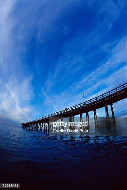 pier and cirrus clouds - david puu stock-fotos und bilder