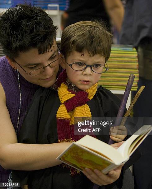 Woman and her son reads "Harry Potter and the Deadly Hallows," the new book in the Harry Potter series by author J. K. Rowling at a bookshop in...